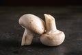 Two Champignon Mushrooms Healthy Food On Dark Black Textured Background