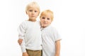 Two charming blond brother children in an embrace on a white background