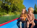 Two charming little children in the small paddle river boat Royalty Free Stock Photo