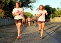 Two Chearful running young girls covered with powder paint Royalty Free Stock Photo