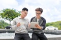 Two cheerful asian business people discussing with documents Royalty Free Stock Photo