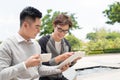 Two cheerful asian business people discussing with documents Royalty Free Stock Photo