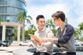 Two cheerful asian business people discussing with documents Royalty Free Stock Photo