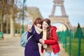 Two cheerful beautiful girls in Paris taking selfie Royalty Free Stock Photo