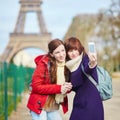 Two cheerful beautiful girls in Paris taking selfie Royalty Free Stock Photo