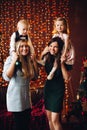 Two mothers sitting with cute kids christmas presents. Royalty Free Stock Photo