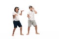 Two cheerful brothers listening music in headphones and dancing Royalty Free Stock Photo