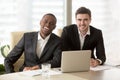 Two cheerful businessmen looking at camera, multiracial business