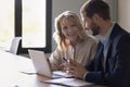 Two cheerful diverse business colleagues talking at laptop Royalty Free Stock Photo