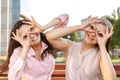 Two cheerful girls fooling around