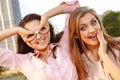 Two cheerful girls fooling around