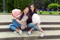 Two cheerful girls having fun with cotton candy outdoor Royalty Free Stock Photo