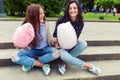 Two cheerful girls having fun with cotton candy outdoor Royalty Free Stock Photo