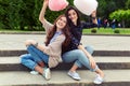 Two cheerful girls having fun with cotton candy outdoor Royalty Free Stock Photo