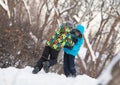 Two cheerful happy boys playing in winter park,