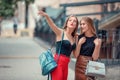 Two cheerful modern female tourists while sight seeing in old town. one woman points up to a sight. other excited woman look up, Royalty Free Stock Photo