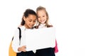 two cheerful multicultural schoolgirls smiling while using laptop isolated on white. Royalty Free Stock Photo