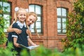 Two cheerful schoolgirls are holding a book in their hands. The first day at school. Concept on the topic Back to School. Royalty Free Stock Photo