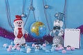 Christmas preparations of cheerful snowmen on blue festive stage