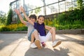 Two cheerful teens riding the skateboard together Royalty Free Stock Photo