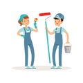 Two cheerful volunteers with paint bucket, brush and roller in hands. Social workers. Kids in blue working overalls Royalty Free Stock Photo