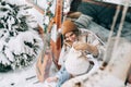 Two cheerful women friends sitting in a van in winter camp and having fun, enjoying holiday Royalty Free Stock Photo