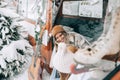 Two cheerful women friends sitting in a van in winter camp and having fun, enjoying holiday Royalty Free Stock Photo