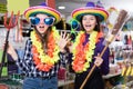 Two cheerful young female friends having fun in festival outfits store Royalty Free Stock Photo