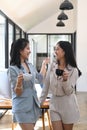 Two young woman office workers talking each other during coffee break. Royalty Free Stock Photo