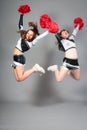 Two Cheerleaders Jumping