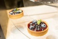 Two cheesecakes with fresh fruits on glass table Royalty Free Stock Photo