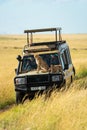 Two cheetah cubs sitting and lying on truck Royalty Free Stock Photo