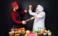 Two chefs fighting with kitchen utensils. Professional culinary. Chefs in uniform compete in culinary show. Cooking Royalty Free Stock Photo