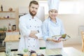 Two Chefs Posing in Kitchen Royalty Free Stock Photo