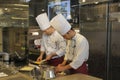 Two chefs preparing homemade pasta