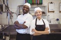 Two chefs standing with arms crossed in the commercial kitchen