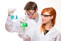 Two chemists holding a test tube in a lab