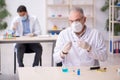 Two male chemists working at the lab during pandemic Royalty Free Stock Photo