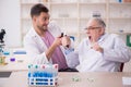 Two male chemists working at the lab