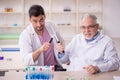 Two male chemists working at the lab