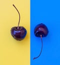 Two cherries on a yellow-blue background.Two yinyan berries Royalty Free Stock Photo