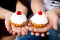 Two cherry cakes on top. Cake hand cupcakes with cream Royalty Free Stock Photo