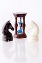 Two chess horses with sand-clock Royalty Free Stock Photo