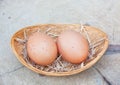 Two chicken eggs in bamboo basket Royalty Free Stock Photo