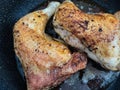 Two chicken legs are fried in a pan in a large amount of oil Royalty Free Stock Photo