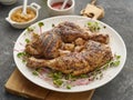 Two chicken legs grilled with garlic on a white plate Royalty Free Stock Photo