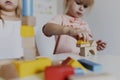 Two child girl sisters playing with colorful wooden toy building blocks Royalty Free Stock Photo