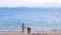 Two child play on beach.beautiful sea