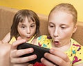 Two child play on your mobile phone. Royalty Free Stock Photo