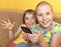 Two child play on your mobile phone. Royalty Free Stock Photo